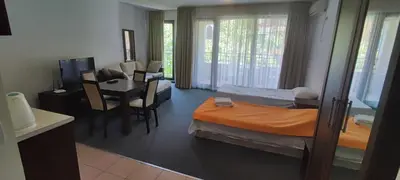 a hotel room with a bed and a desk and a table at Marina in Aheloy