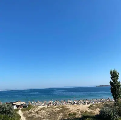 a beach with a large group of people on it at Golden Hacienda in Sozopol