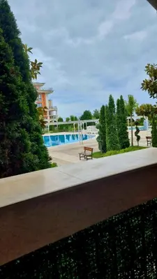 a park with a bench and a pool at Prestige Fort Beach apartment in Sveti Vlas