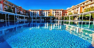 a large pool of water in front of some buildings at Prestige Fort Beach apartment in Sveti Vlas