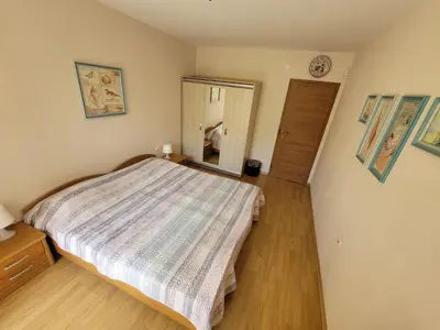 a small bedroom with a bed and a mirror at Prestige Fort Beach apartment in Sveti Vlas