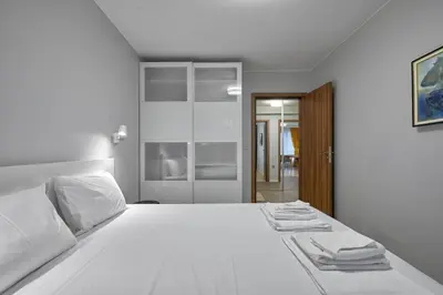 a bedroom with a white bed with towels on it at The little things apt - Parking & Own EV Chаrgеr by Flat Mаnаger in Burgas City