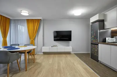 a kitchen and a dining room with a table and a kitchen at The little things apt - Parking & Own EV Chаrgеr by Flat Mаnаger in Burgas City
