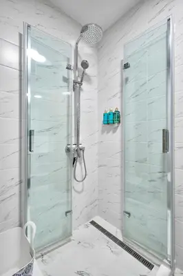 a shower with a glass door in a bathroom at The little things apt - Parking & Own EV Chаrgеr by Flat Mаnаger in Burgas City