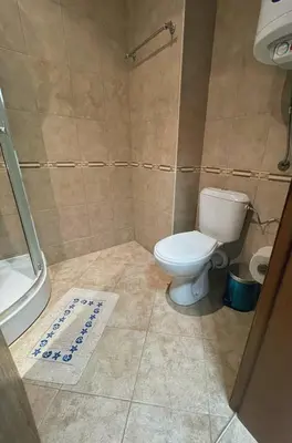a bathroom with a white toilet and a shower at GreenStudio w Sveti Vlas in Sveti Vlas