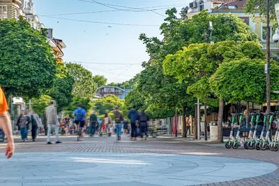 a group of people walking down a street at Flamingo Top Center Apartment in Varna City