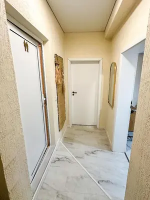 a hallway of a house with a white door at Flamingo Top Center Apartment in Varna City