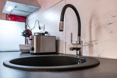 a kitchen sink with a faucet on a counter at Flamingo Top Center Apartment in Varna City