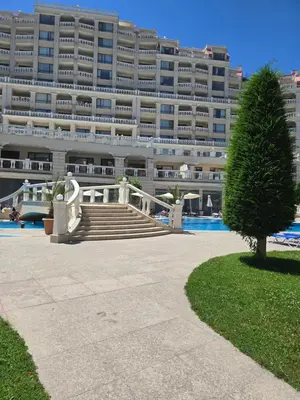 a large building with a staircase in front of a building at South Bay Apartment - Varna in Varna City