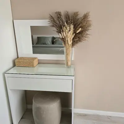 a table with a vase on it with a mirror at South Bay Apartment - Varna in Varna City