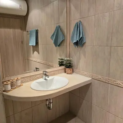 a bathroom with a sink and a mirror at South Bay Apartment - Varna in Varna City