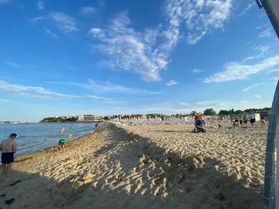 a group of people standing on a beach at MIRAMAR A 501 Private Apartment Sunny Beach in Sunny Beach