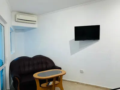 a living room with a chair and a table at MIRAMAR A 501 Private Apartment Sunny Beach in Sunny Beach