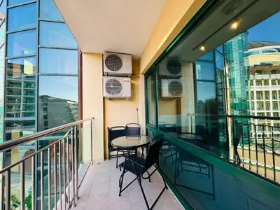 a balcony with a table and chairs on it at MIRAMAR A 501 Private Apartment Sunny Beach in Sunny Beach