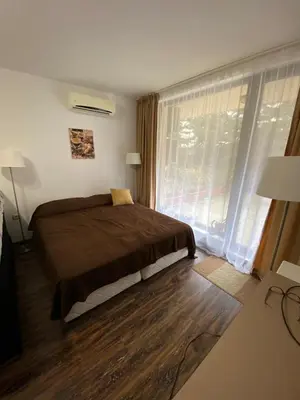 a bedroom with a bed and a large window at Studio Kristina in Pomorie