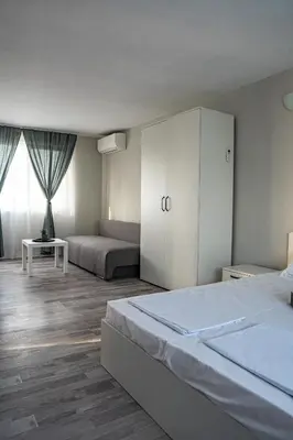 a bedroom with a large bed and a white cabinet at Saint Anastasia lozenets in Lozenets