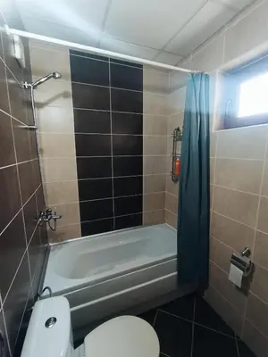 a bathroom with a toilet and a bath tub at Bulgapart Obzor in Obzor