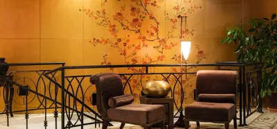 a lobby with two chairs and a painting on the wall at The Cliff Hotel and Holiday Apartments by Flat Mаnаger in Obzor