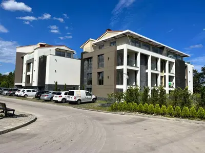 a building with cars parked in a parking lot at Double studio Petra B2-5 in Byala