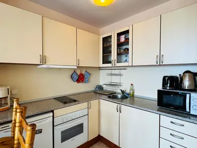 a kitchen with white cabinets and a microwave at LAZUR 1 Apartment 7- 5 Sveti Vlas in Sveti Vlas