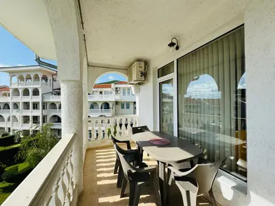 a balcony with a table and chairs and a building at LAZUR 1 Apartment 7- 5 Sveti Vlas in Sveti Vlas