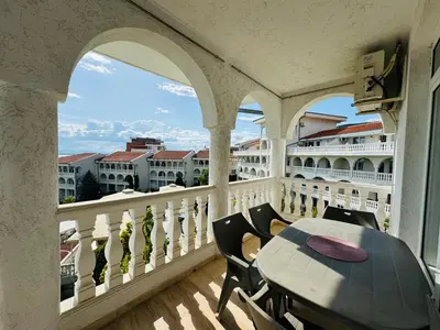 a balcony with a table and chairs on a balcony at LAZUR 1 Apartment 7- 5 Sveti Vlas in Sveti Vlas