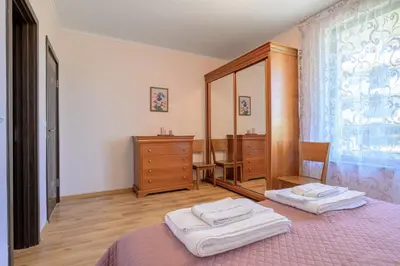 a bedroom with a bed and a dresser and a mirror at Infinity view 2 Shkorpilovci in Shkorpilovtsi