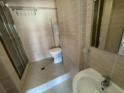 a small bathroom with a toilet and a sink at Menada Kalia Apartments in Sunny Beach