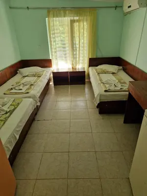 two beds in a room with a window at Хижа 