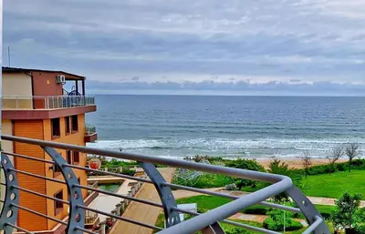 a view of the ocean from a balcony of a building at Амон Ра in Primorsko
