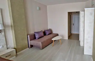 a living room with a couch and a table at Амон Ра in Primorsko