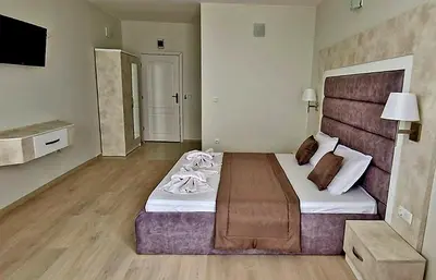 a bedroom with a large bed in a room at Амон Ра in Primorsko