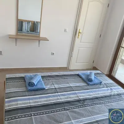 a bed with two blue towels on it in a room at 2 Bed Suite, Exclusive Sea Views in Sozopol