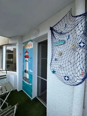a room with a wall with a painting of a lighthouse at Sea Treasure in Varna City