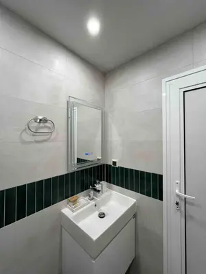 a white bathroom with a sink and a mirror at Sea Treasure in Varna City