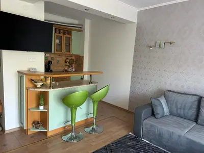 a living room with a couch and a table at Nesebar City Apartment in Nesebar