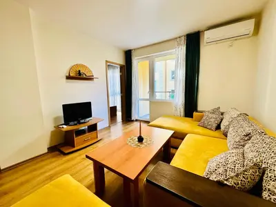 a living room with a couch and a table at Vacation apartments Daneli in Sunny Beach
