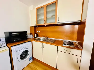 a kitchen with a sink and a washing machine at Vacation apartments Daneli in Sunny Beach