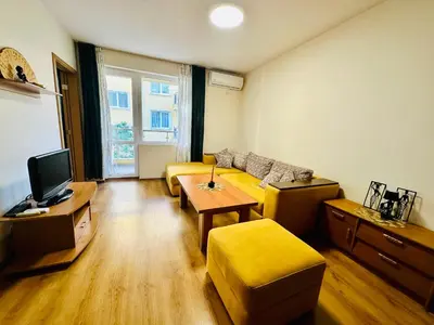 a living room with a couch and a tv at Vacation apartments Daneli in Sunny Beach