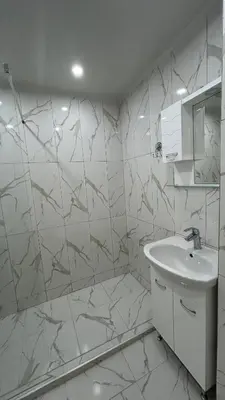 a white bathroom with a sink and a mirror at Zigrabay lovely appartments in Primorsko