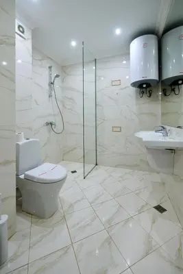 a bathroom with a toilet and a shower and a sink at Sea view Apartment Pomorie in Pomorie