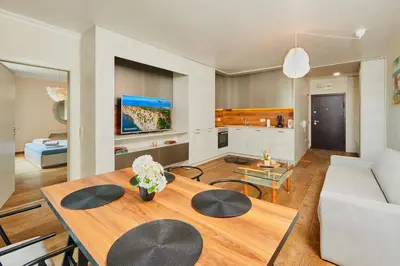 a living room with a table and a couch at Sea view Apartment Pomorie in Pomorie