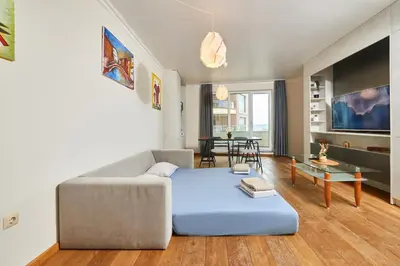 a living room with a couch and a table at Sea view Apartment Pomorie in Pomorie
