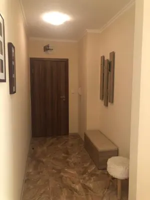 a hallway with a door and a stool in a room at Apartment Alex Sveti Vlas in Sveti Vlas