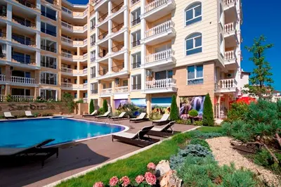 a large apartment building with a swimming pool in front of it at Apartment Alex Sveti Vlas in Sveti Vlas