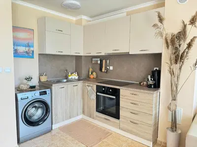 a kitchen with a washing machine and a washer at MaYana Beach Appartament in Burgas City