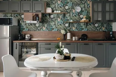a kitchen with a white table and chairs in it at Стилен и уютен апартамент в центъра Варна in Varna City