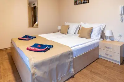 two pillows are sitting on top of a bed at Private Apartment in PREMIER FORT Beach Aparthotel in Sveti Vlas