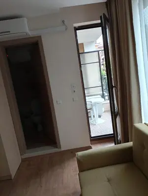 a living room with a mirror and a couch at Private Apartment in PREMIER FORT Beach Aparthotel in Sveti Vlas