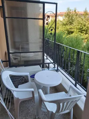 a balcony with a table and two chairs and a view at Private Apartment in PREMIER FORT Beach Aparthotel in Sveti Vlas